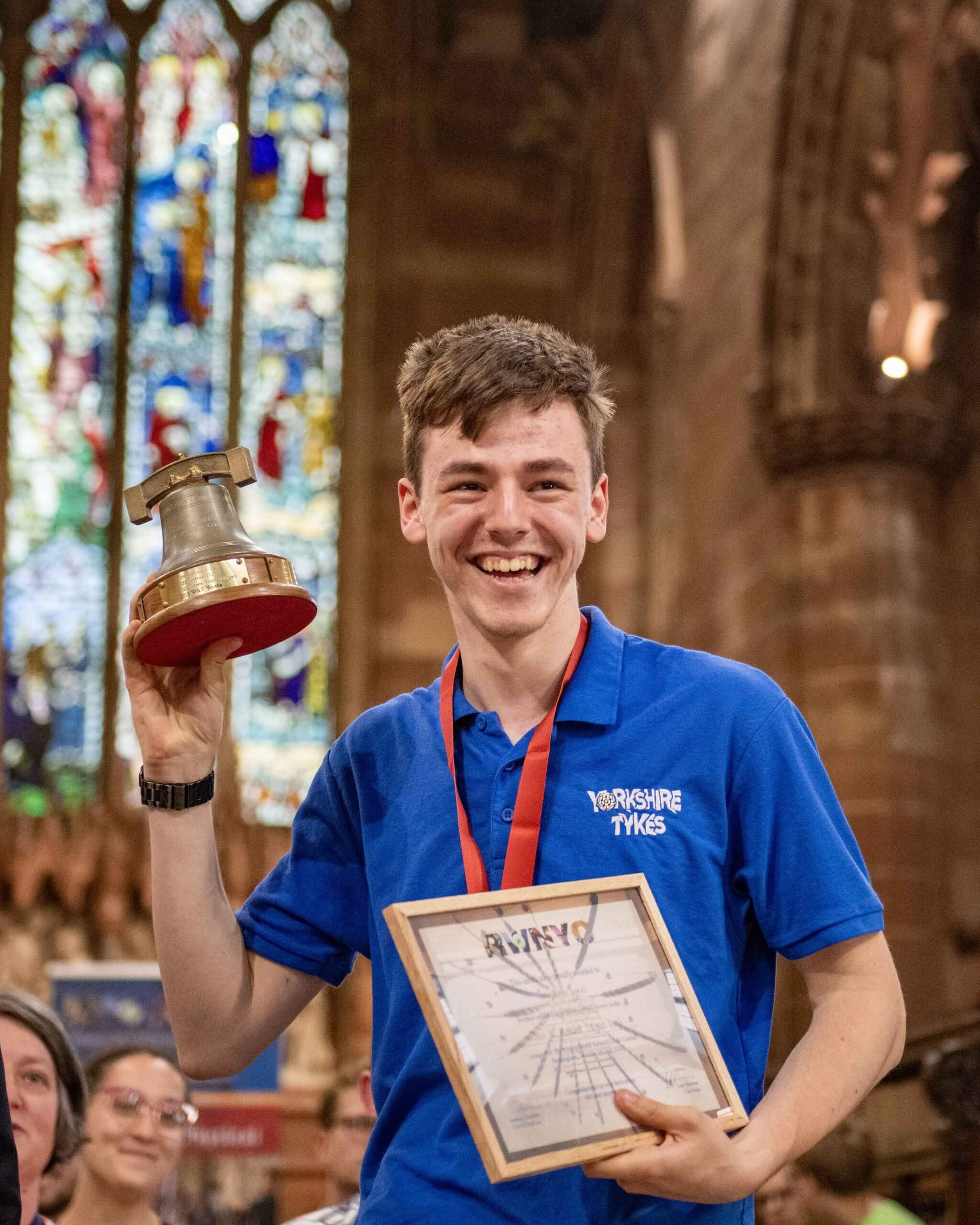A contest winner holding the trophy